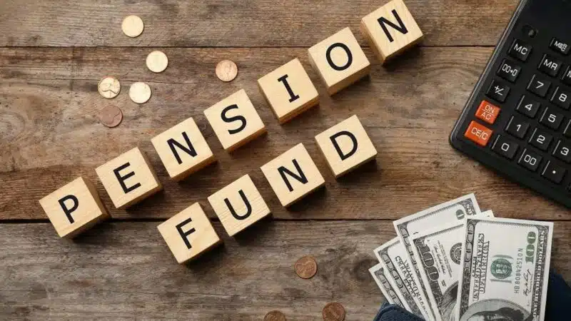 Pension funds rebalancing concept with calculator and cash