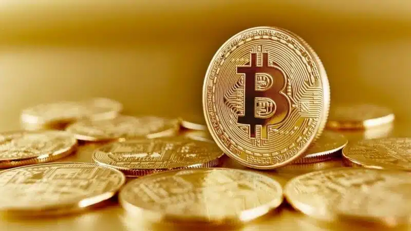 Bitcoin cryptocurrency with golden background