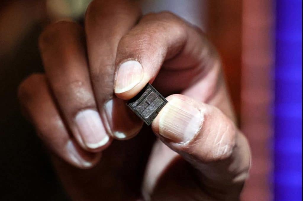 Micron Technology CEO holds a chip at the New York Stock Exchange