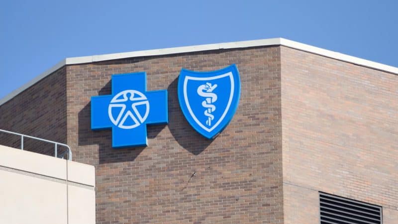 Blue Cross Blue Shield headquarters high-rise building with logo on glass facade BCBS settlement