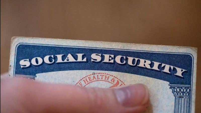 Person holding a Social Security card social security administration may payments
