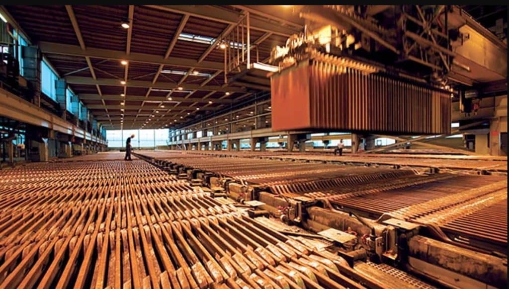 Copper refinery floor showing rows of copper cathode plates in active production
