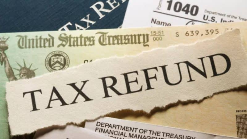 IRS tax refund documents including Form 1040 and a United States Treasury check for taxpayers still waiting on their 2026 refund
