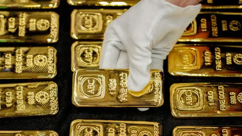 1kg ABC Fine Gold 999.9 bars being handled with white gloves - gold price ATH and correction