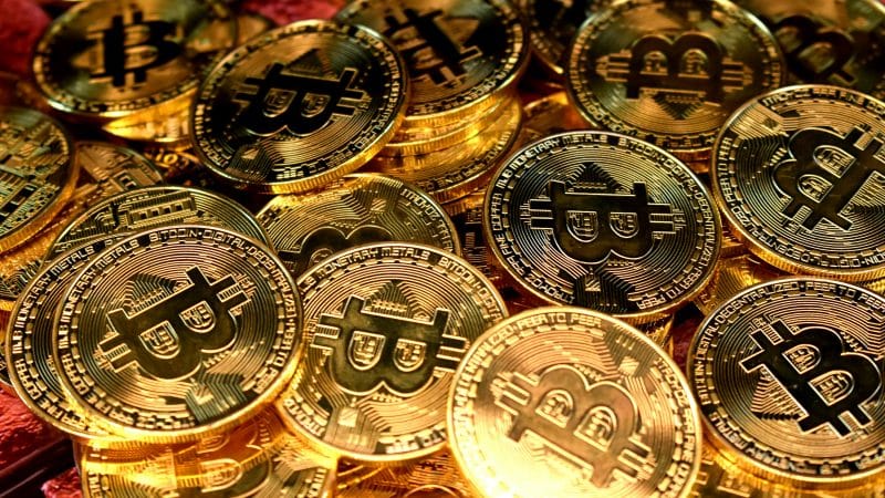 Image of Bitcoin coins representing CLARITY Act Bitcoin, BlackRock Bitcoin, Bitcoin 200K prediction, crypto market structure bill, and Wall Street Bitcoin adoption.