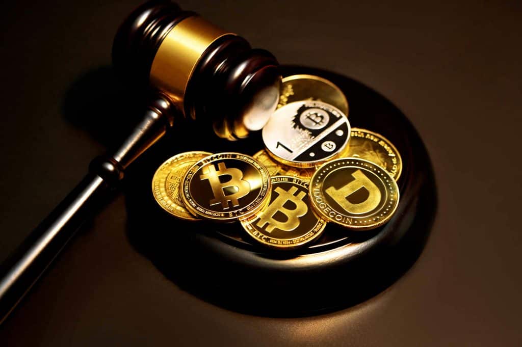 Image of a judge's gavel and cryptocurrency coins representing CLARITY Act, Christopher Giancarlo, CLARITY Act Senate vote, CFTC crypto regulation, and US crypto legislation.
