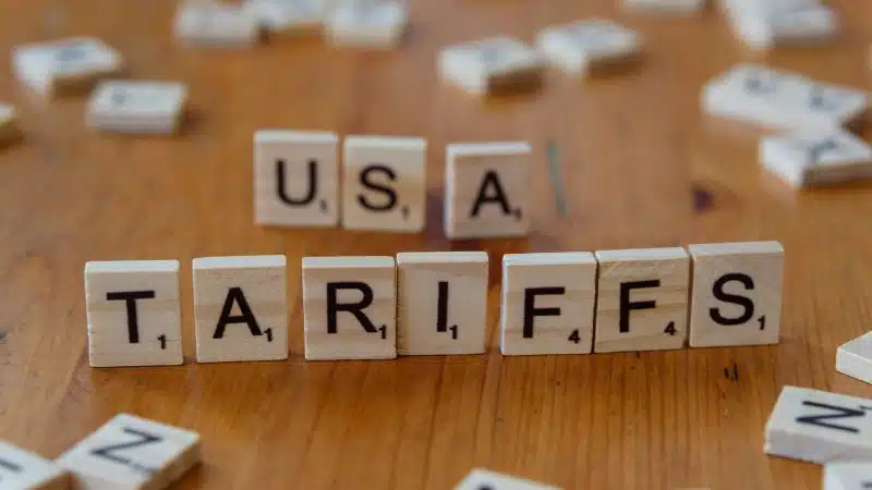 Wooden letter tiles spelling "USA Tariffs," representing Trump tariffs, Section 301 tariffs, Supreme Court tariffs, US import tariffs, and forced labor tariffs affecting global trade