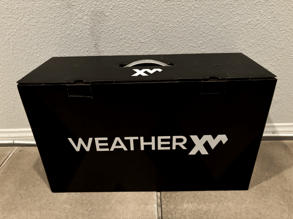 Weatherxm logo printed on a balckj box