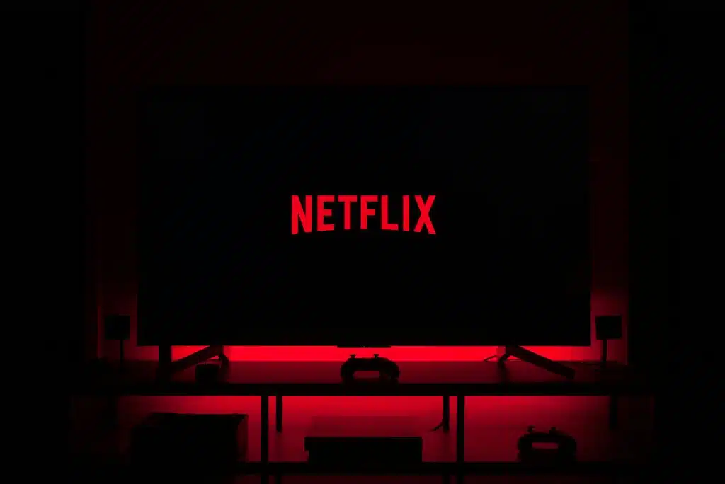 Netflix logo on TV amid Netflix news on Netflix Stock, Netflix stock down, Netflix share forecast, and Netflix price