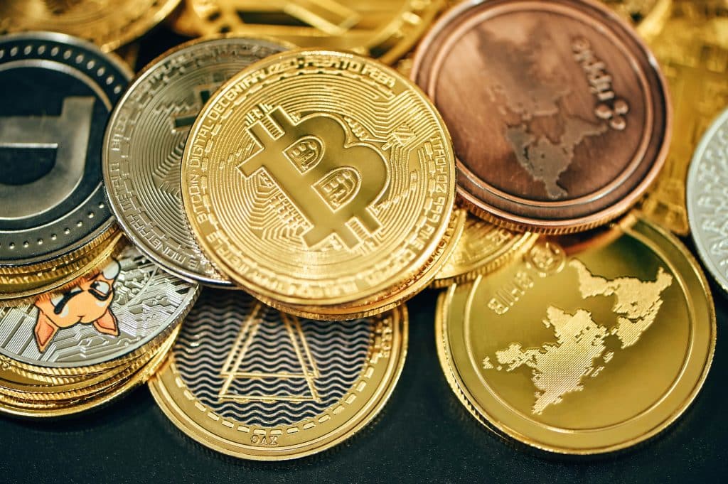 Multiple cryptocurrency coins illustrating crypto ETF inflows, Federal Reserve liquidity, and the crypto bull market.