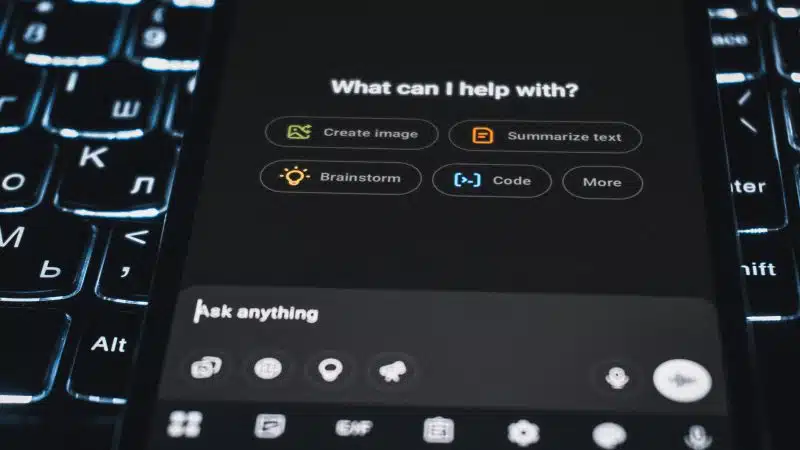 Big Tech AI spending concept showing ChatGPT on a smartphone, highlighting AI infrastructure spending, Oracle AI spending, corporate debt, and AI spending concerns.