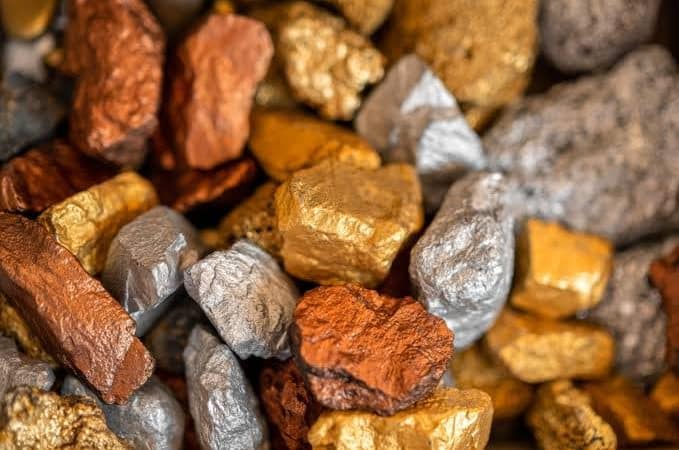 Gold, copper and silver metal ore nuggets representing gold tokenization, digital gold, rare earth mining, US Japan rare earths and tokenized metals.