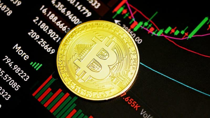 A Bitcoin coin sits over a trading chart, highlighting the Bitcoin August rally, Bitcoin September outlook, Brian Armstrong CLARITY push, CLARITY Act passing, and US crypto regulation.