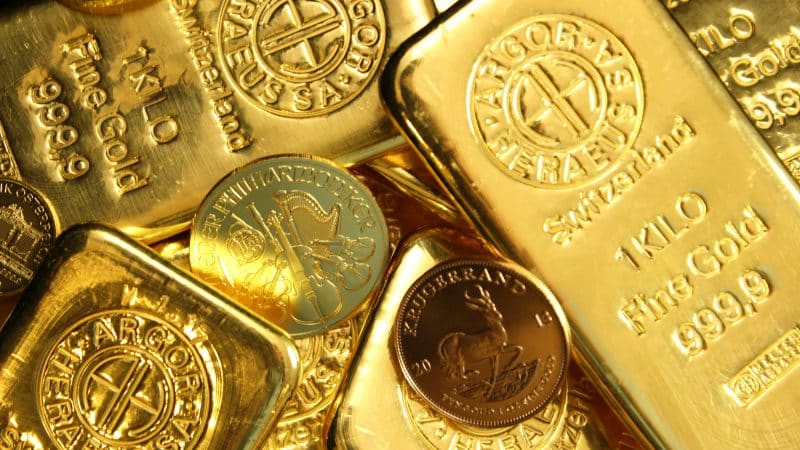 Gold price image showing gold bars and coins with a focus on rising Gold ETF inflows, Gold ETF demand, and a positive Gold price outlook following the latest Gold price target.